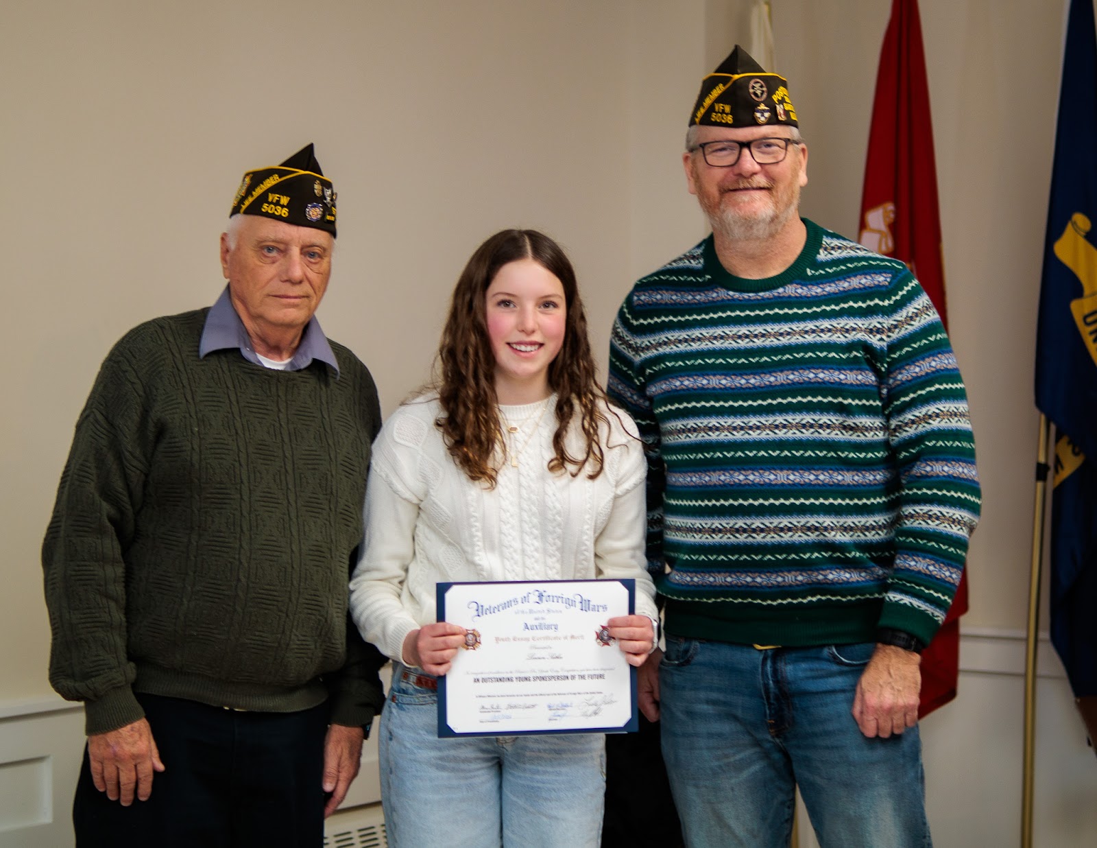 A local student stands with Post 5036 veterans after receiving Patriot's Pen recognition